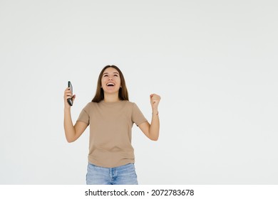 Successful happy woman holding obile phone isolated on a white background