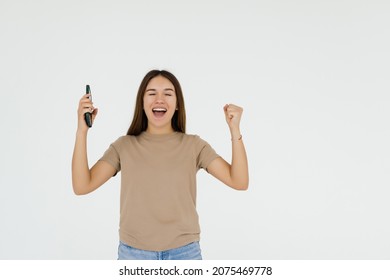 Successful happy woman holding obile phone isolated on a white background