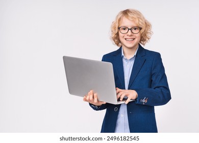 Successful happy young preteen boy male child kid elementary primary middle school pupil holding laptop netbook computer standing in formal clothes eyeglasses isolated on white background copy space - Powered by Shutterstock