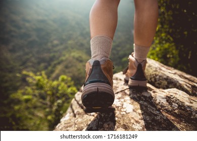 Successful hiker enjoy the view on mountain top cliff edge - Shutterstock ID 1716181249
