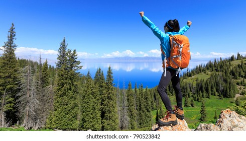 successful Hiker outstretched arms stand at cliff edge on mountain top - Powered by Shutterstock