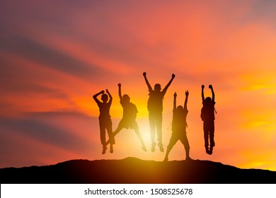 Successful Human And Fighting Spirit, Silhouette Group Young, People Are Delighted By Show Of Hands Higher. Succeed. Business, Successful, Achievement, Teamwork And Goal Concept.