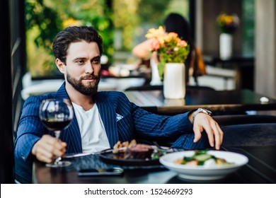 Successful Intelligent Business Man Relaxing In A Luxury Restaurant Outdoors, Confident Thoughtful Entrepreneur, Wealthy Men Pensive Rest And Waiting Someone In The Modern Coffee Shop Terrace.