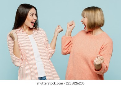 Successful lucky happy cool elder parent mom with young adult daughter two women together wear casual clothes do winner gesture clench fist isolated on plain blue cyan background. Family day concept - Shutterstock ID 2255826235