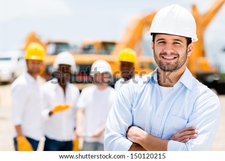 Successful male architect at a building site with arms crossed 