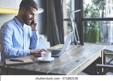 Successful Male Owner Of Business Company Talking With Operator While Making Banking Online Consulting About Cash Remittance Paying For Bills Using Wireless Internet And Modern Laptop In Cabinet