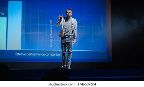 Successful Male Speaker Stands On Stage, Greets Audience And Presentation Of The New Product, Shows Infographics, Statistics Animation On Screen. Live Event  Device Release  Start-up Conference