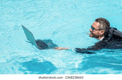 successful man. Businessman in suit with laptop in swimming pool. business man on summer vacation. businessman in wet suit in swim pool. Remote working. Summer business dreams. swimming freelancer - Shutterstock ID 2368238665