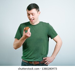 successful man eating cookies, studio photo over black background