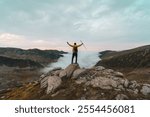 Successful man hiker on top of mountain. Man reaching the summit. Success and adventure. 