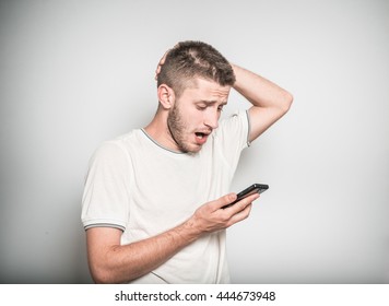 successful man looking upset on the phone isolated on a gray background - Powered by Shutterstock