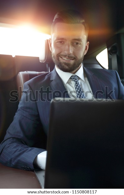 successful man
sitting in the back seat of a
car