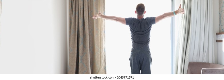 Successful Man Stands In Bedroom Near Bright Window