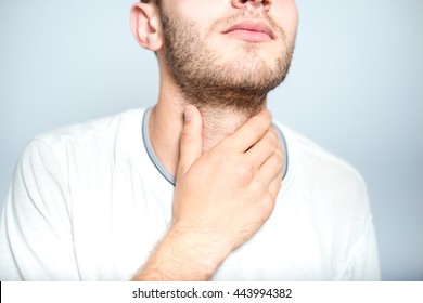 Successful Man With Strep Throat, Isolated On A Gray Background