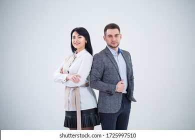 Successful Man In A Suit And A Woman Future Businessmen Are Smiling And Talking About A New Project. Business Partners Stand On A White Background.