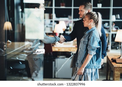 Successful meeting handshake. Three business people in the office discuss new work plan - Shutterstock ID 1322837996