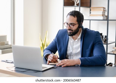 Successful Middle Aged Businessman Hot Line Worker IT Support Working Remotely In Headset At Home Office. Front View Portrait Of A Tutor Lecturer Teacher On E-learning Listening To Webinar