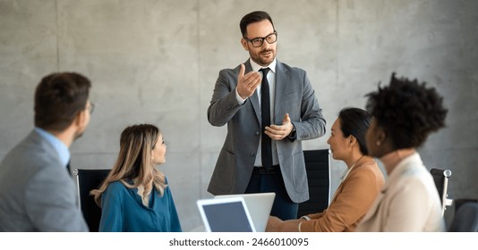 Successful multiethnic business people presenting analytical report while working together in office - Powered by Shutterstock