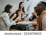 Successful multiracial business people enjoying a relaxing lunch break together.