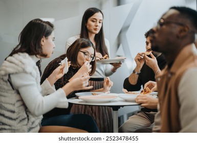 Successful multiracial business people enjoying a relaxing lunch break together.