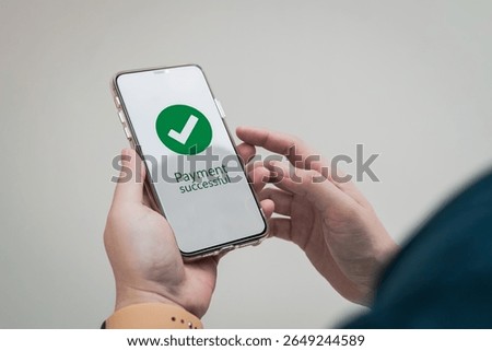 A successful payment notification message appears on the customer's smartphone screen when they make a payment via an online banking application.