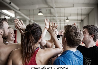 Successful People Giving High Five To Each Other In Gymnasium