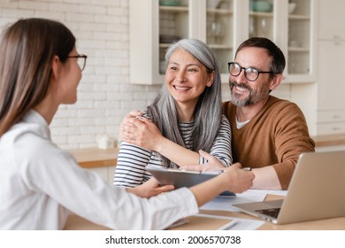 Successful Positive Deal. Lawyer Financial Advisor Helping Consulting Showing Contract Mortgage Loan Credit Business Startup, Signing Documents By Matute Middle-aged Couple At Home