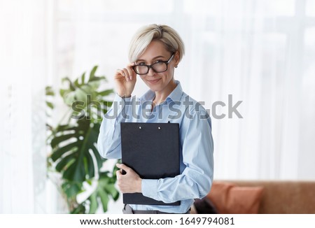 Successful Psychologist. Professional Counselor Lady Holding Folder Smiling To Camera Standing In Office.