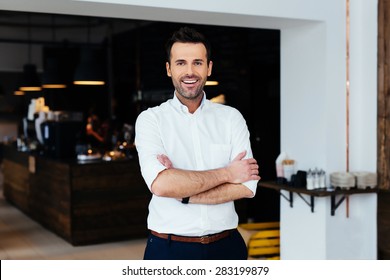 Successful restaurant manager standing with crossed arms