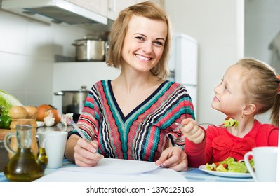 Successful Russian Woman And Her Daughter Working With Papers From Home