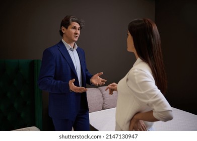 Successful Sales Rep, Manager, Assistant In Upholstered Furniture Store Showroom Presents Orthopedic Mattresses To Female Customer, Helping Her To Make Purchase For Home Improvement. Interior Design