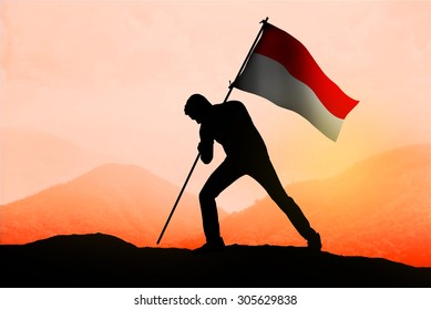 Successful Silhouette Man Waving Indonesian Flag On Top Of The Mountain Peak