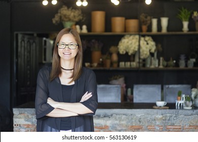 Successful small business owner standing In Coffee Shop