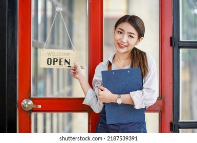 Successful Small Business Startup Small Business Owner SME Beauty Girl Standing Checklist In Front Of A Coffee Shop Picture Of An Asian Female Barista Cafe Owner. SME Entrepreneur Seller Business Idea