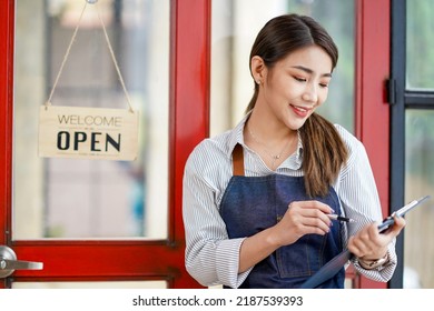 Successful Small Business Startup Small Business Owner SME Beauty Girl Standing Checklist In Front Of A Coffee Shop Picture Of An Asian Female Barista Cafe Owner. SME Entrepreneur Seller Business Idea