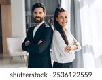 Successful, smiling Hispanic businesspeople wearing stylish formal wear with crossed arms posing looking at camera. Happy managers working in office. Business concept