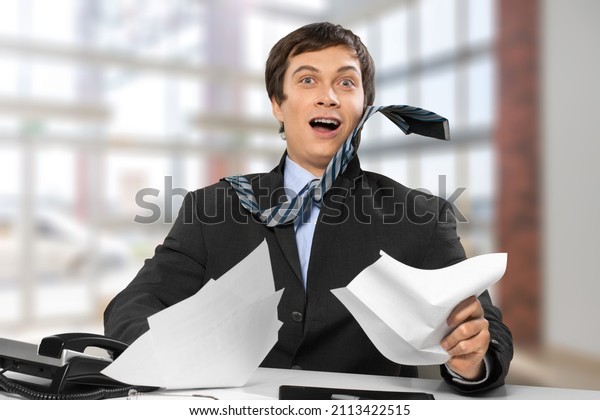 Successful smiling man shop assistant\
receptionist in formal attire\
writing
