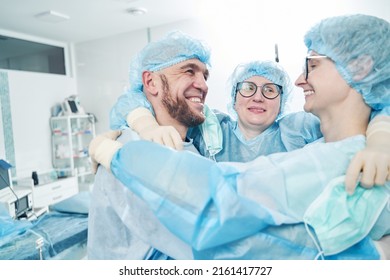 Successful Surgical Team Embracing In Surgery Theater