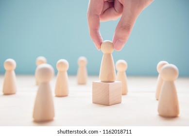 Successful team leader, Businessman hand choose people standing out from the crowd.