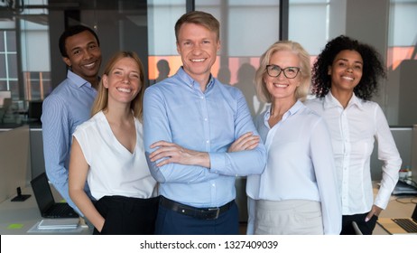 Successful Team Leader And Diverse Employees Posing For Photo Together, Smiling Businesspeople Looking At Camera, Standing In Modern Office, Feeling Proud, Multiracial Company Staff Photo