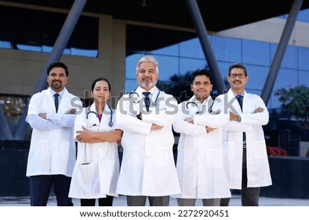 Successful team of medical doctors standing in hospital.