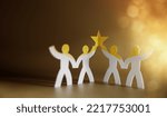 Successful Teamwork Concepts. Paper Cut as Group of Worker Raise Up a Star Together. Business Strategy. Working to Committed and Towards a Shared Goal. Colleagues or Partnership Celebrating a Success