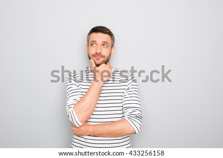 Successful thoughtful young businessman thinking about smth