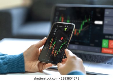 Successful of trader use phone and laptop trading stock exchange graph money of block chain stock market cryptocurrency selling and buy with price chart data graph,business financial funds - Powered by Shutterstock