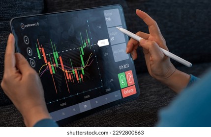 Successful of trader use tablet computer trading stock exchange graph, money, block chain, stock market, cryptocurrency, selling and buy with price chart data graph, business, financial, funds - Shutterstock ID 2292800863