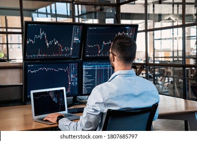 Successful trader working in modern office, looking at display, sale and buy bitcoin and analyzing index on cryptocurrency market diagram