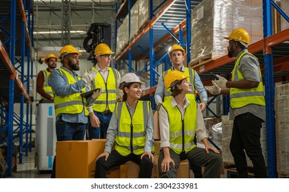 Successful warehouse team smiling happily,Cheerful logistics workers in a large distribution warehouse,Logistic and business export,Industrial and industrial workers concept. - Powered by Shutterstock