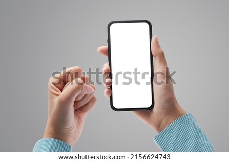 Successful winning woman holding a smartphone with blank screen and celebrating, POV shot