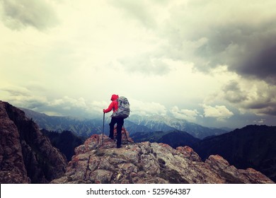 successful woman backpacker enjoy the view on mountain peak - Shutterstock ID 525964387