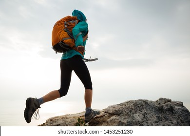 Successful Woman Hiker Running To On Seaside Mountain Peak Cliff Edge